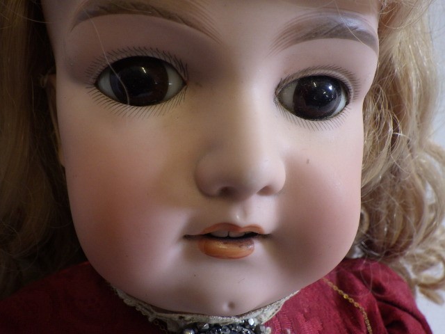 A large Armand Marseille bisque socket head doll with fixed brown glass eyes Image