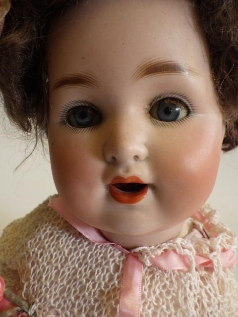 A German bisque socket head character crying doll with blue glass sleeping eyes Image