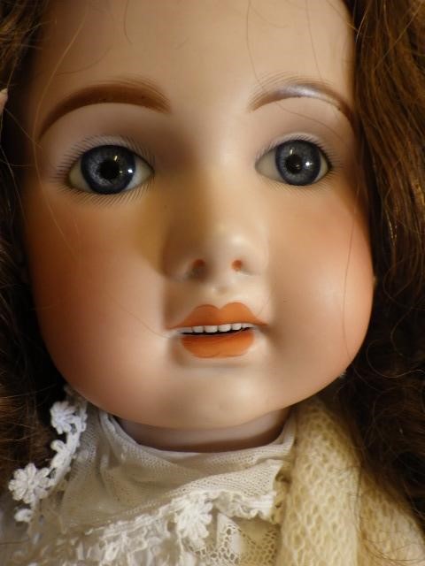 A large Jumeau bisque socket head doll with fixed blue glass eyes Image