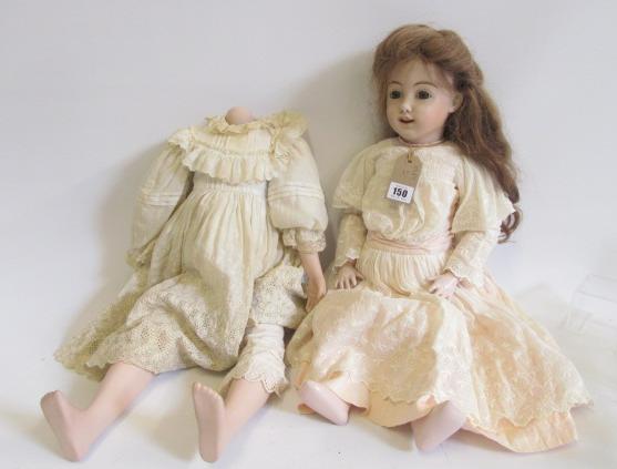 A mid 20th century bisque head doll with brown glass eyes Image