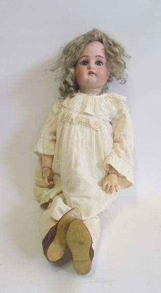A Kammer & Reinhardt bisque head doll with blue glass sleeping eyes Image