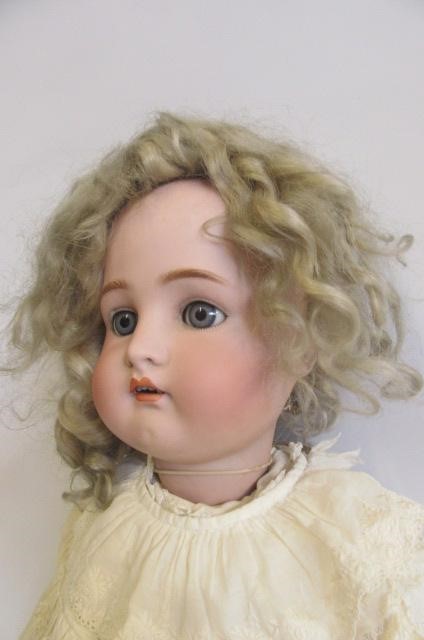 A Kammer & Reinhardt bisque head doll with blue glass sleeping eyes Image