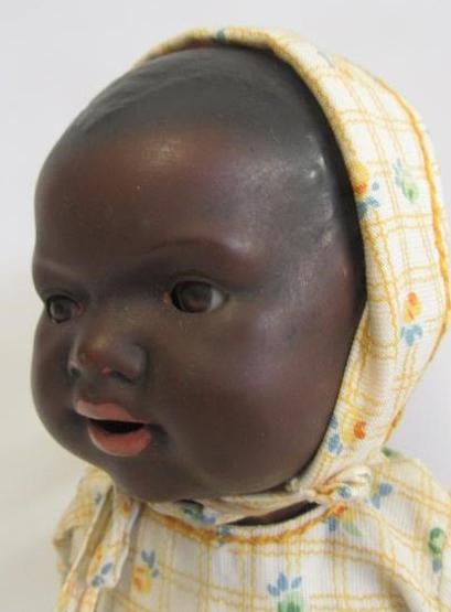 An Armand Marseille bisque head black baby doll with brown glass sleeping eyes Image