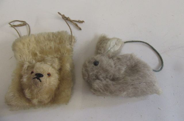A teddy purse covered in long beige plush with black/amber eyes Image