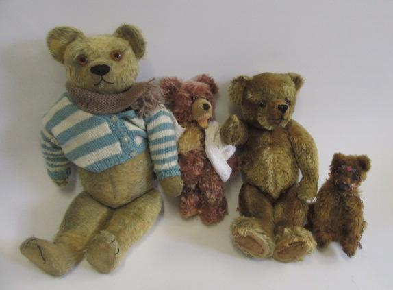 A mid 20th century teddy bear in worn pale gold plush Image