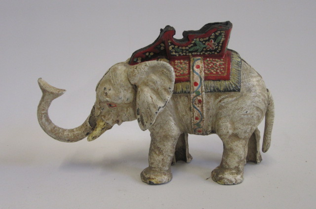 A cast iron money box in the form of an elephant with howdah Image