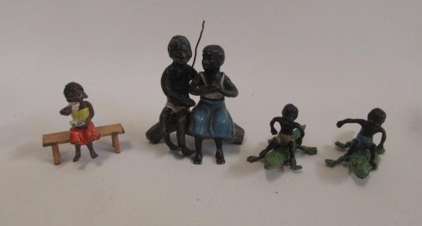 Four cold painted metal blackamoor figures comprising couple seated on trunk Image