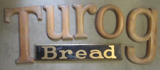 A Turog bread sign comprising five free standing pine letters and a gilt painted wood "Bread" panel Image
