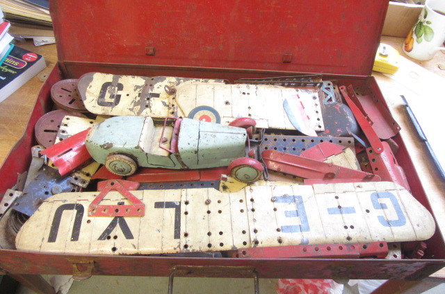 A quantity of Meccano parts including a biplane and a motor car Image