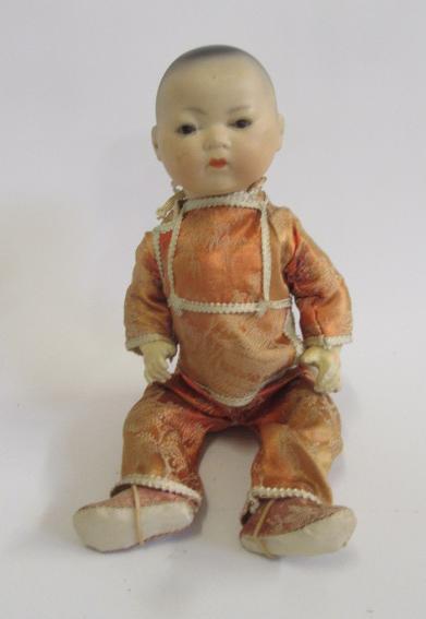 An Armand Marseille bisque head Oriental boy doll with brown glass sleeping eyes Image