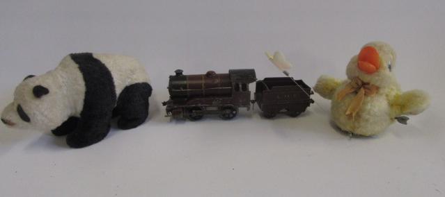 Three clockwork toys comprising O gauge 0-4-0 locomotive and tender (LMS maroon) Image