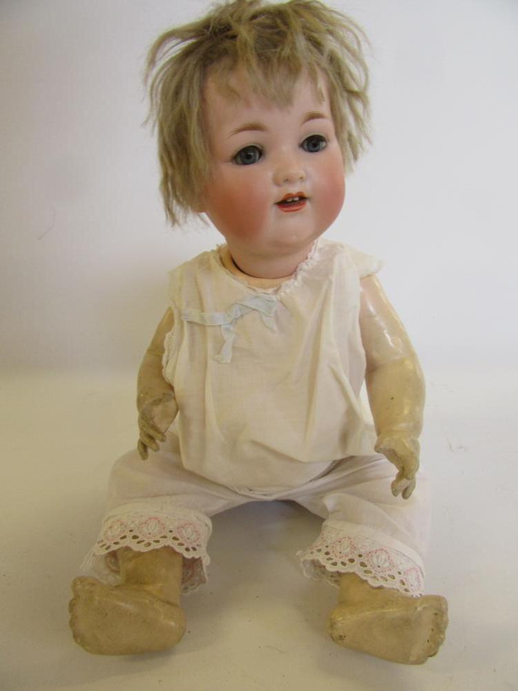An Armand Marseille bisque head character doll with blue glass sleeping eyes Image