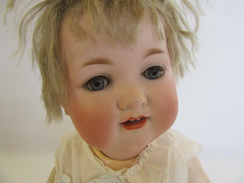 An Armand Marseille bisque head character doll with blue glass sleeping eyes Image