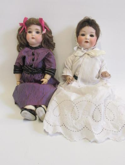 An Ernst Heubach bisque head doll with blue glass sleeping eyes Image