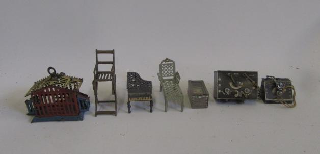 Seven miniature dolls' house items including bird cage Image