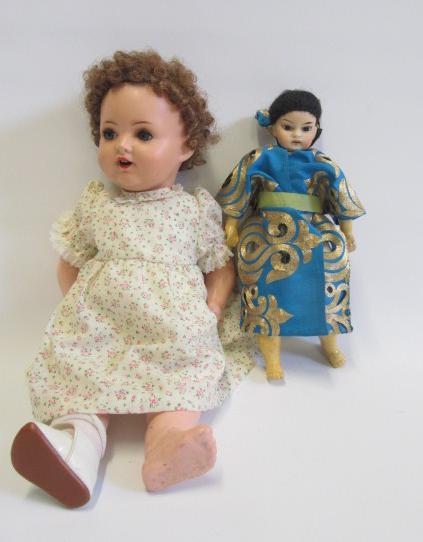 A Hugo Wiegand sprayed bisque head doll with blue glass sleeping eyes Image
