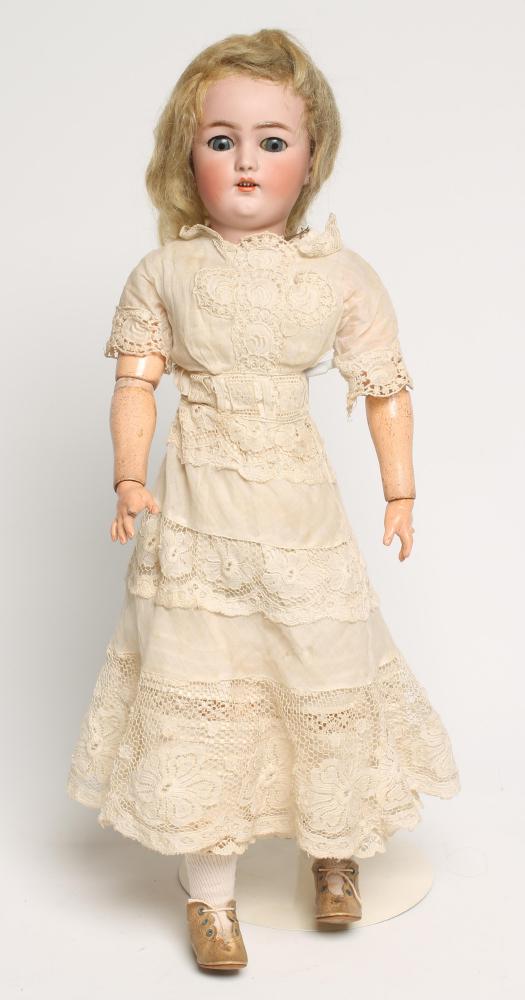 A Simon & Halbig bisque head doll with blue glass sleeping eyes Image