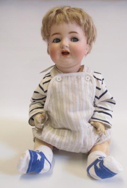 A Kammer & Reinhardt bisque head character doll with blue glass flirty eyes Image