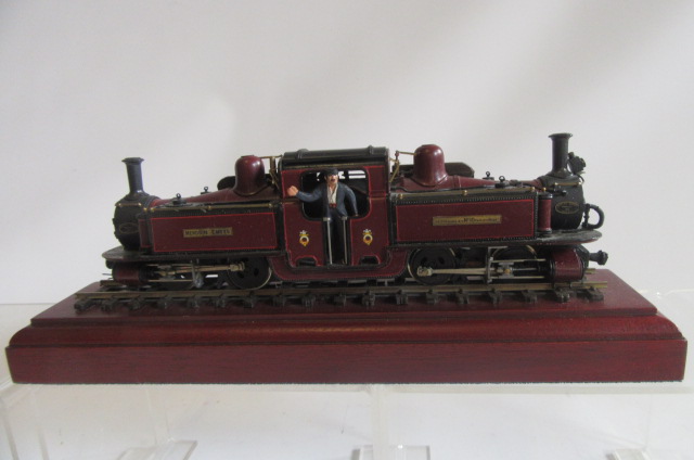 A 7mm OO gauge Merddin Emrys narrow gauge locomotive finished in maroon lined red with display stand Image