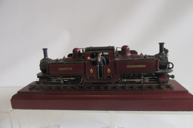 A 7mm OO gauge Merddin Emrys narrow gauge locomotive finished in maroon lined red with display stand Image