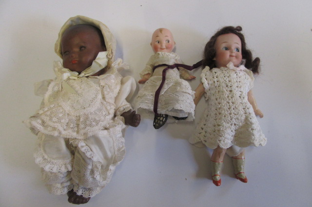 An Armand Marseille bisque head black baby doll with brown sleeping eyes Image