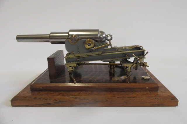 A model canon in steel with brass fittings comprising 8 1/2" cannon on detailed wheeled base Image