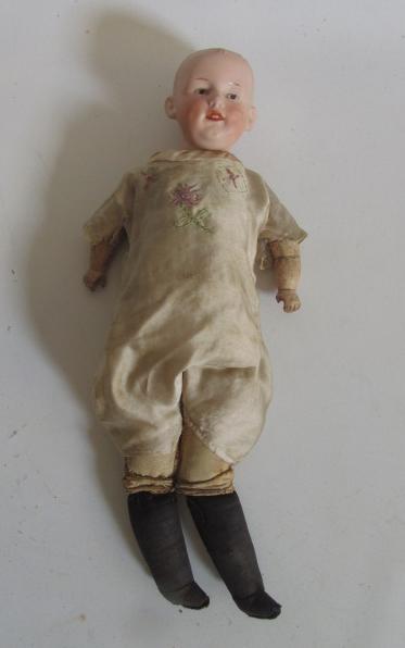 A Gebruder Heubach shoulder head boy doll with intaglio eyes Image