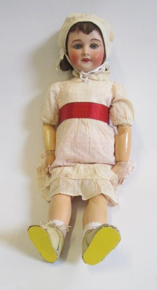 An S.F.B.J. bisque head doll with blue glass sleeping eyes Image