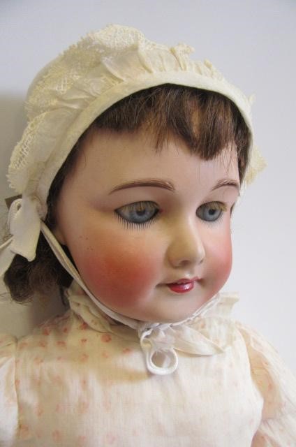 An S.F.B.J. bisque head doll with blue glass sleeping eyes Image