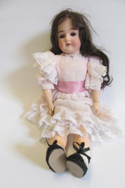 An Armand Marseille Queen Louise bisque head doll with fixed brown glass eyes Image