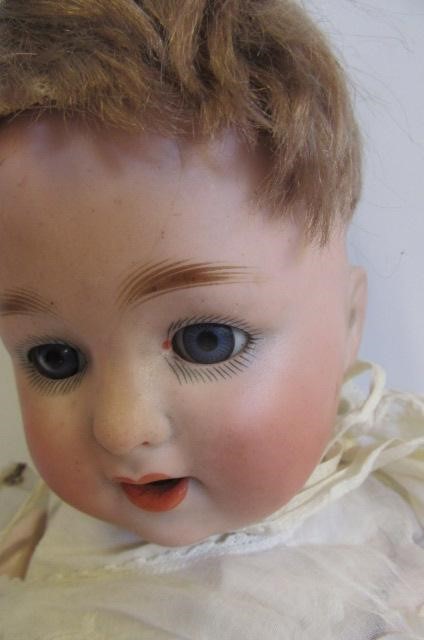 A Schutzmeister & Quendt bisque head doll with blue glass sleeping eyes Image