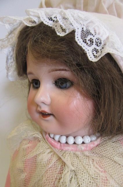 An S.F.B.J. bisque head doll with blue glass sleeping eyes Image