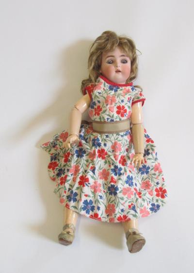 A Kammer & Reinhardt bisque head doll with blue glass sleeping eyes Image