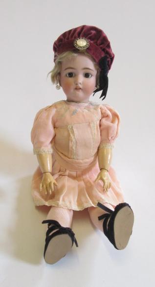 A Simon & Halbig bisque head doll with fixed brown glass eyes Image