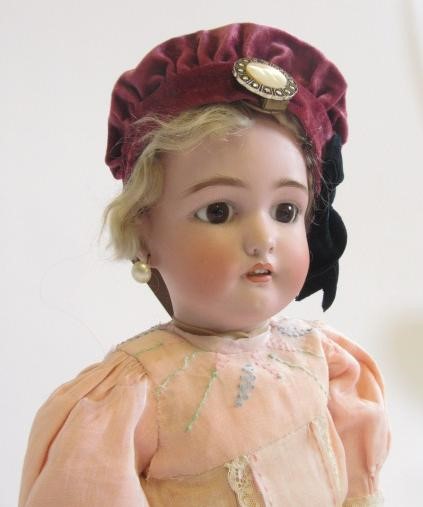 A Simon & Halbig bisque head doll with fixed brown glass eyes Image