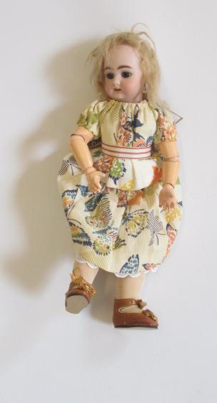 A Simon & Halbig bisque head doll with blue glass sleeping eyes Image