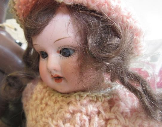 An Armand Marseille bisque head doll with blue glass sleeping eyes Image