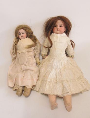 An Armand Marseille bisque shoulder head doll with brown glass sleeping eyes Image