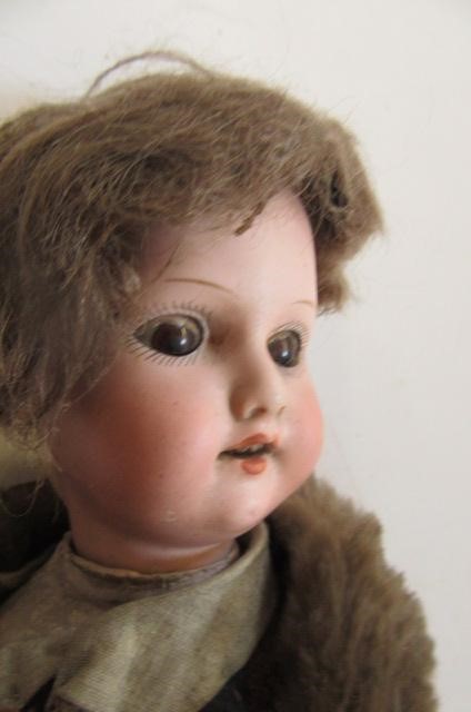 An Armand Marseille bisque head doll with brown glass sleeping eyes Image