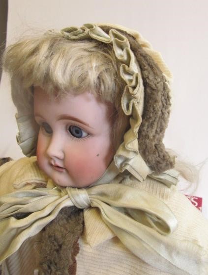 A large Armand Marseille bisque shoulder head doll with blue glass sleeping eyes Image