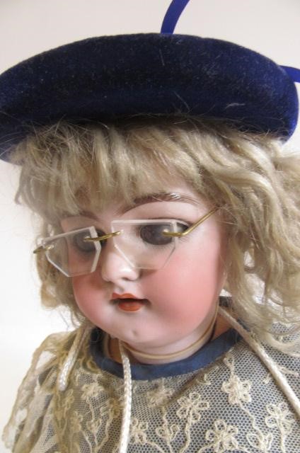 A Simon & Halbig bisque head doll with brown glass sleeping eyes Image