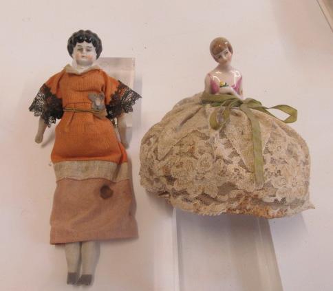 A china shoulder head doll with painted face and hair Image