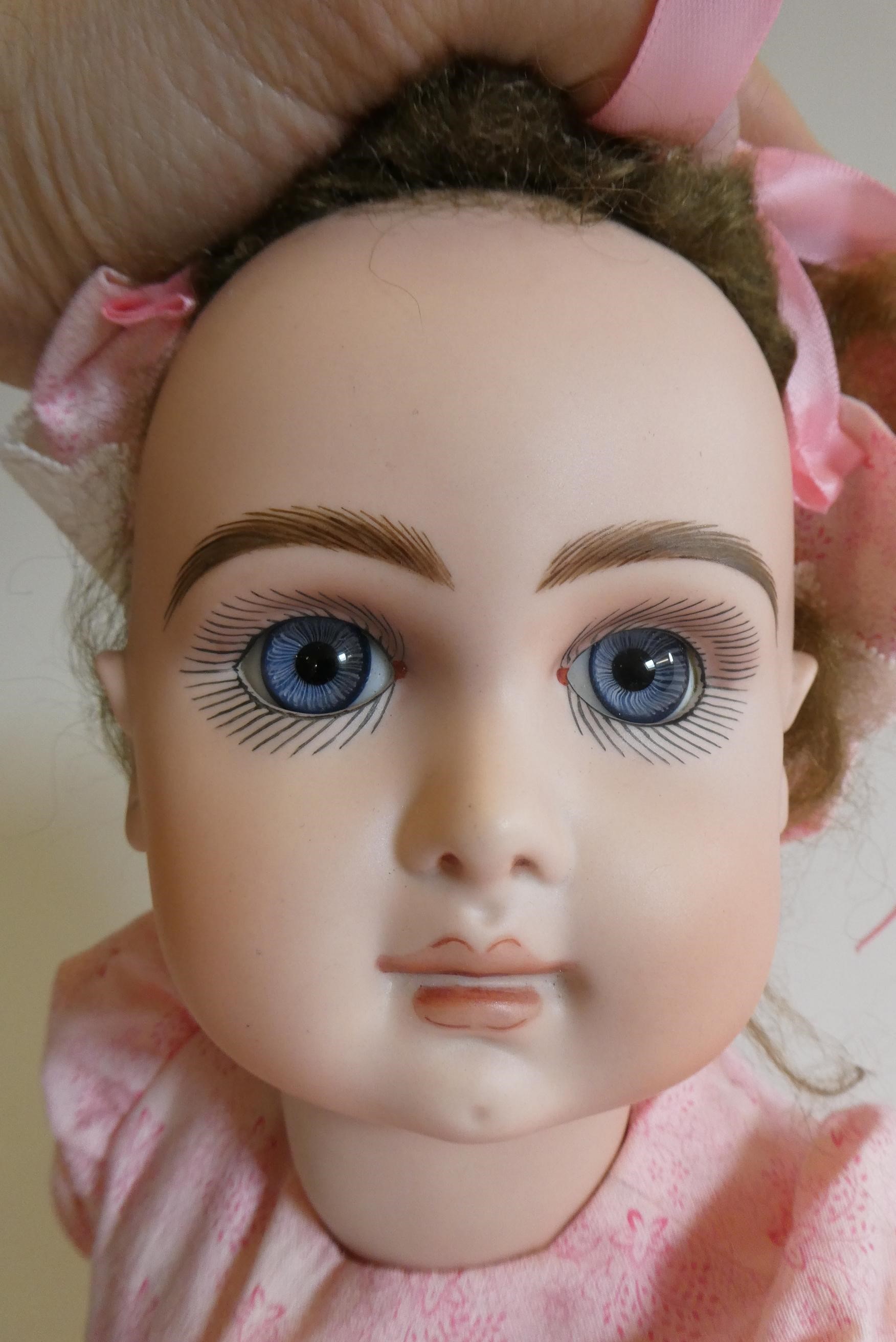 A reproduction "Jumeau" bisque socket head doll with blue glass fixed eyes Image