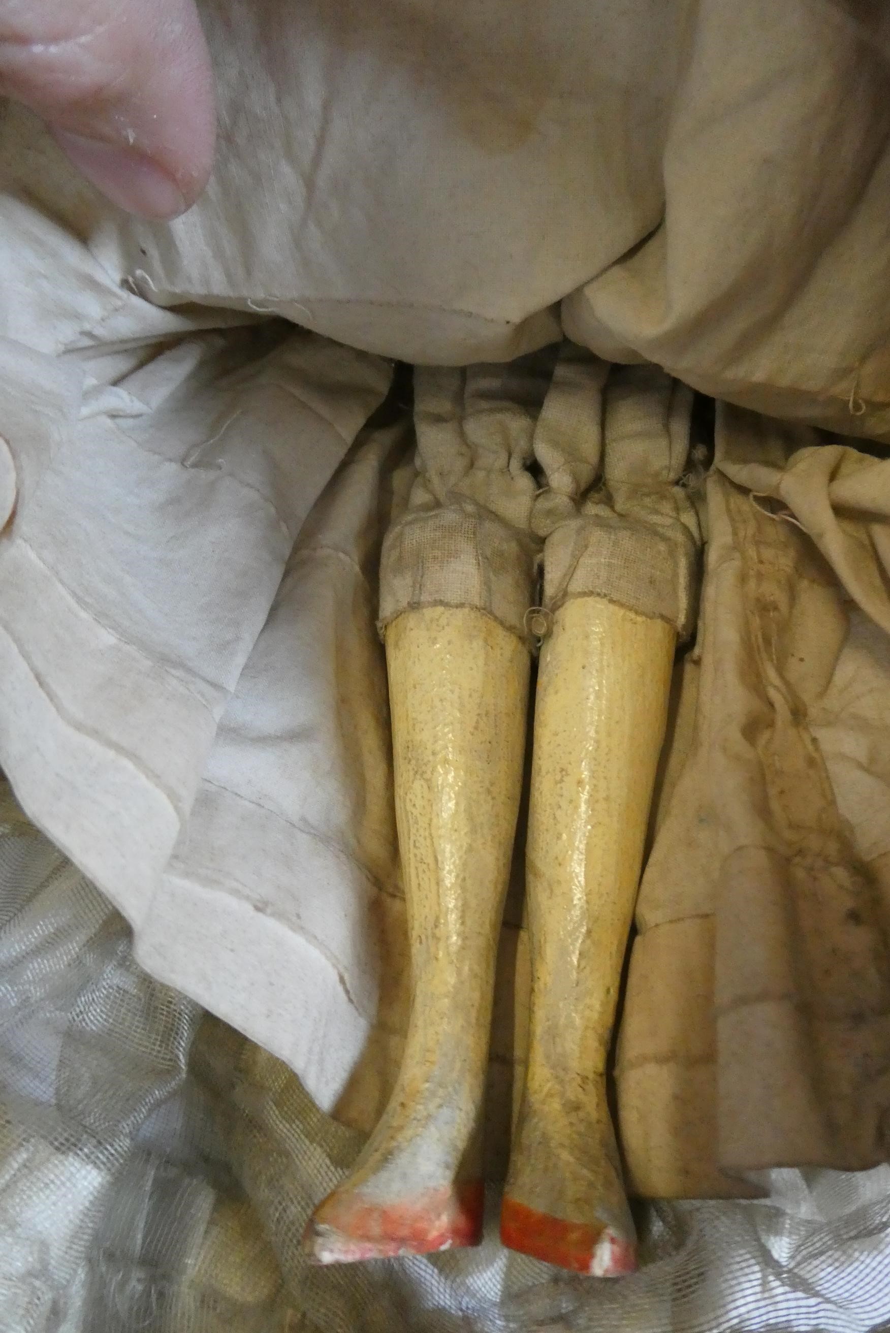 A Victorian peg doll with carved and painted head and torso, cloth upper limbs and carved wooden Image