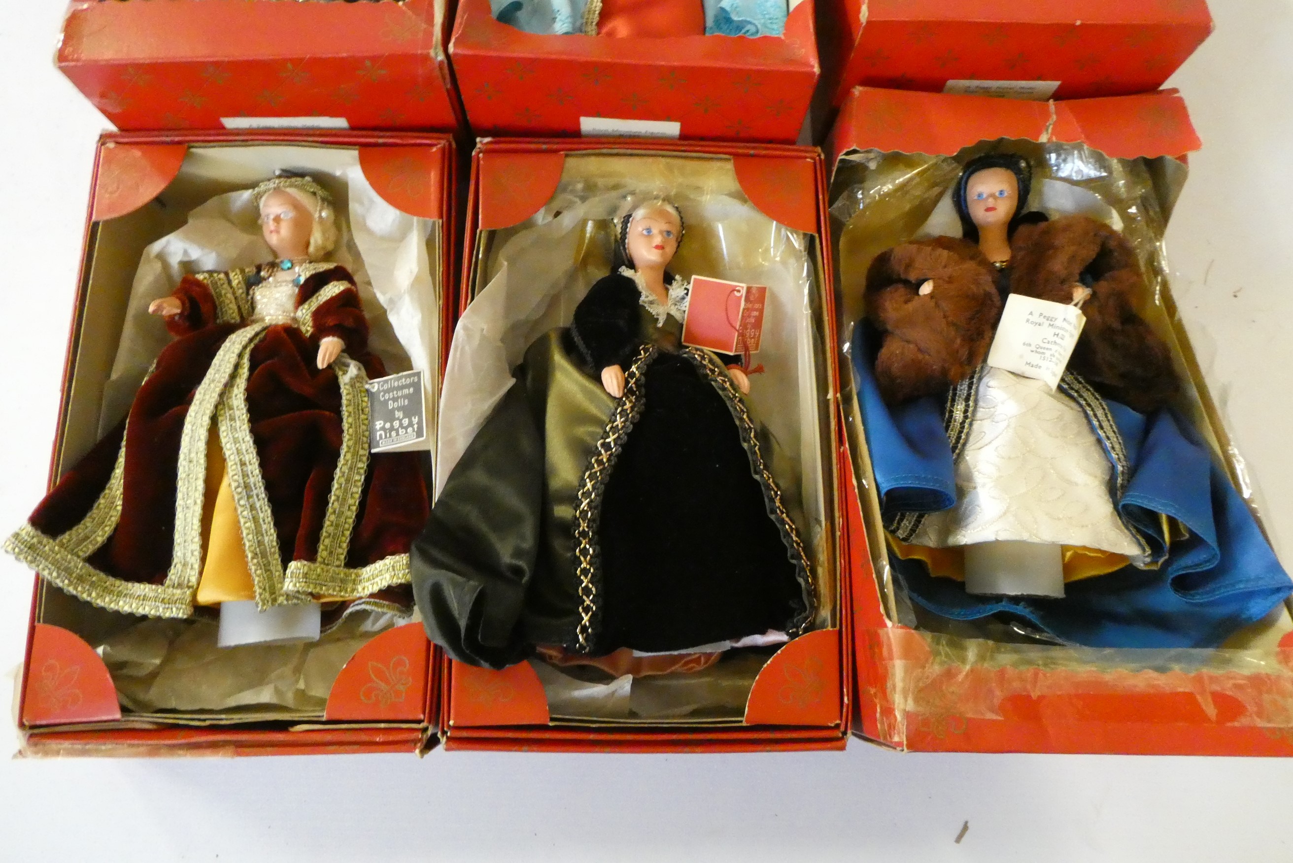 Nine Peggy Nisbet dolls comprising two Henry the VIII dolls, his six wives, and Churchill, together Image