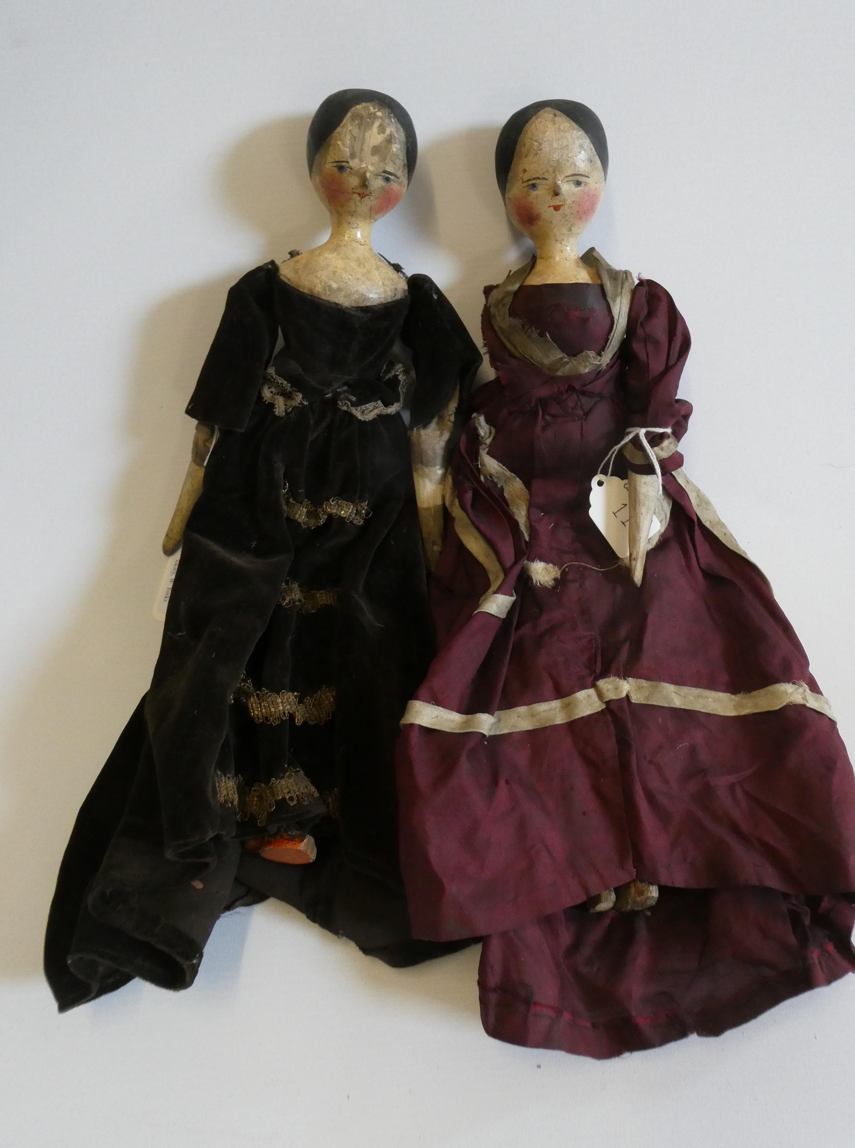 Two Victorian peg dolls with carved and painted head and torso, cloth upper limbs and carved wooden Image