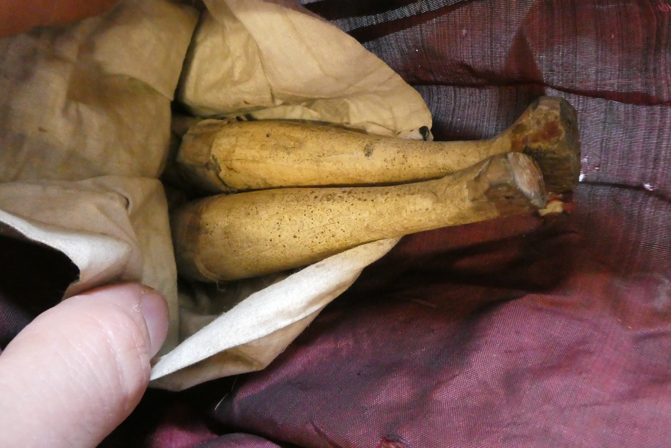 Two Victorian peg dolls with carved and painted head and torso, cloth upper limbs and carved wooden Image