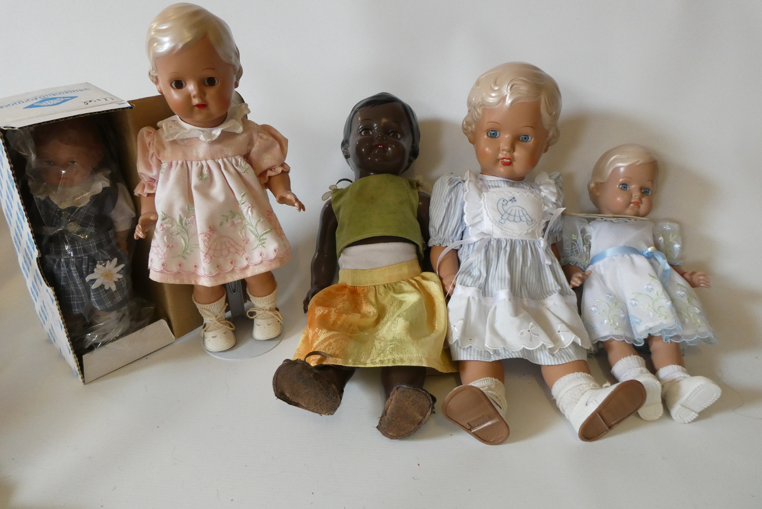 Five Schildkrot-Puppen jointed celluloid dolls, with moulded hair and original outfits, one boxed Image