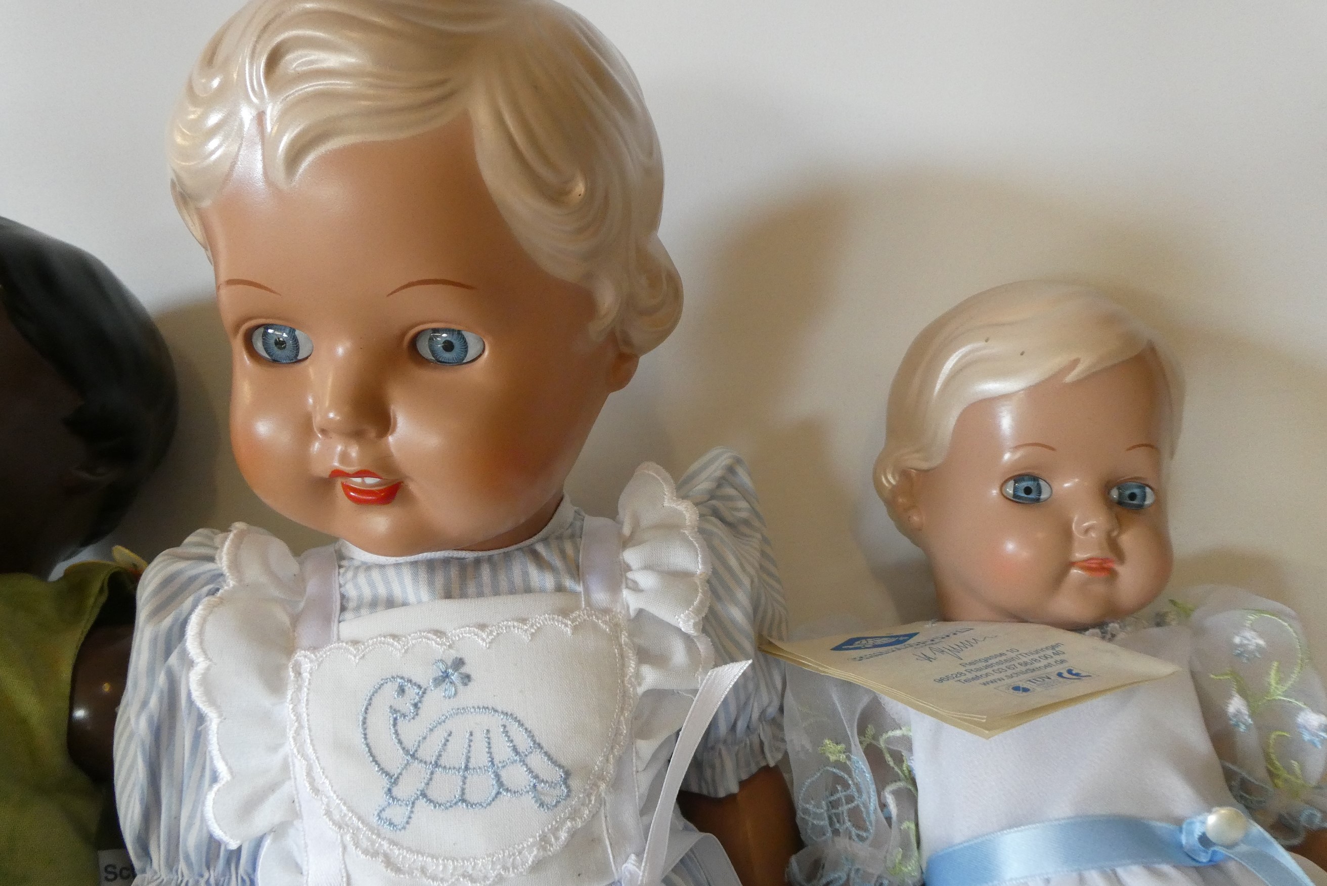 Five Schildkrot-Puppen jointed celluloid dolls, with moulded hair and original outfits, one boxed Image