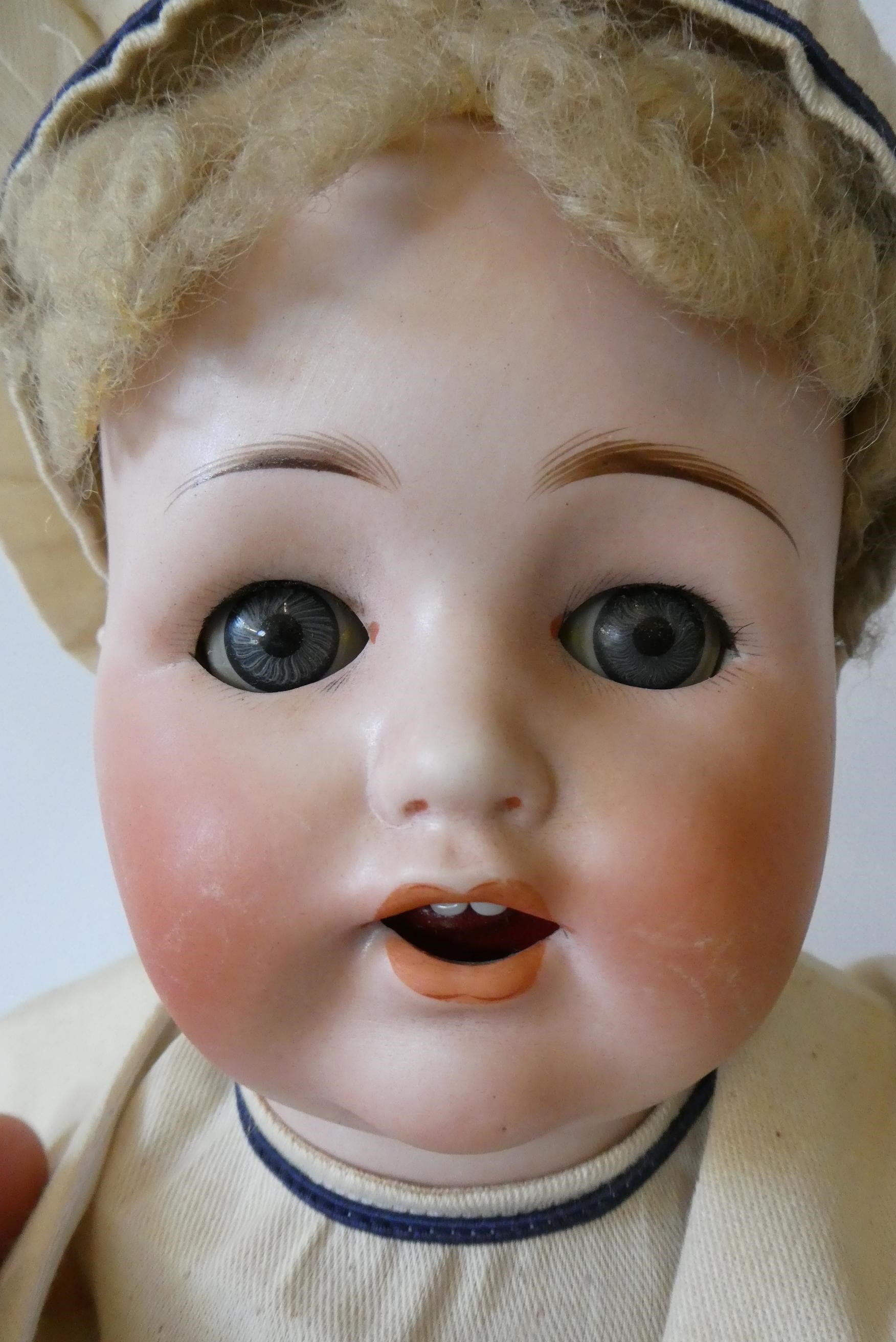 A Max Handwerck Bebe Elite bisque socket head sailor doll with blue glass sleeping eyes Image